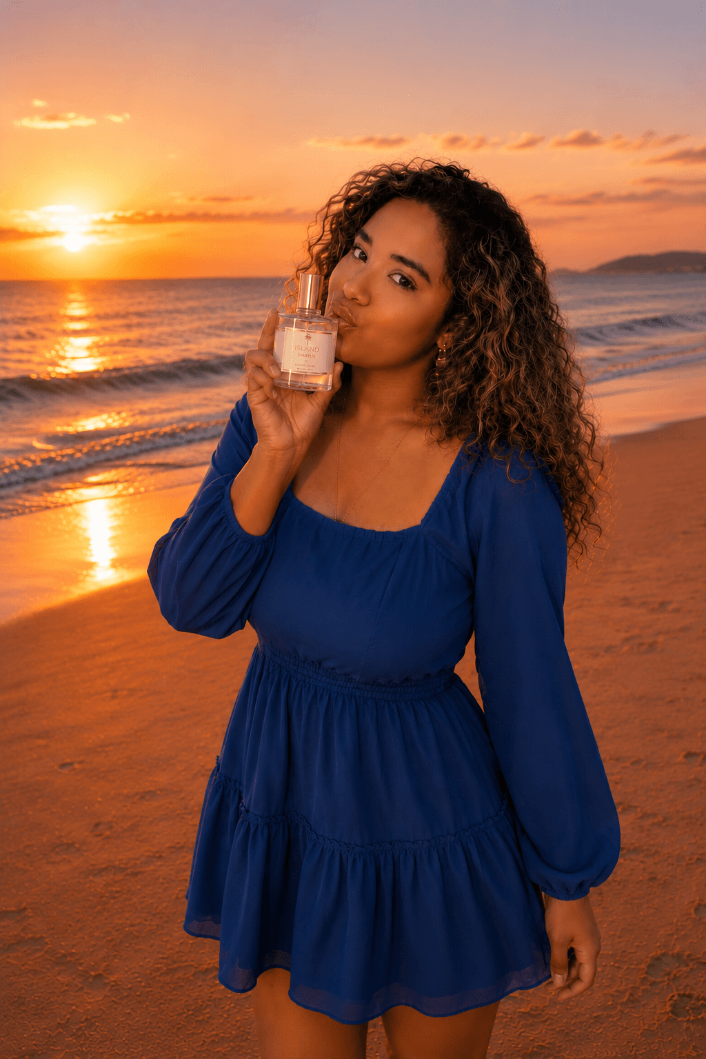 Founder Bhanuja Bakthavaksalan seated by the sea in blue with a flower tucked into her hair